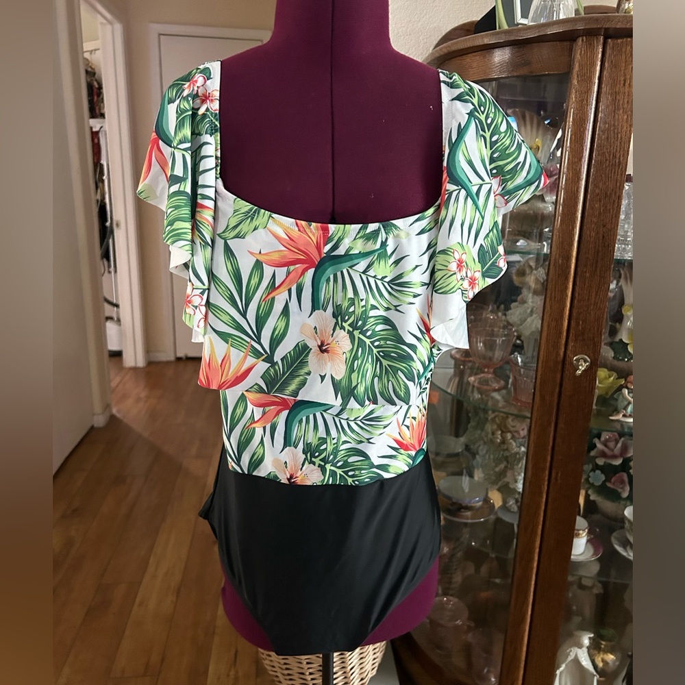 One Piece Bathing Suit With Tropical Design. Ruffled Neckline.